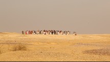 men and women running through a desert 