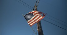 American, USA flag blowing in the wind in slow motion on fourth of July, Independence Day.