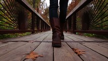 leather boots walking on a wood deck 