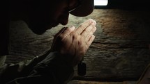 Soldier praying with hands folded on veterans day 