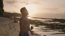 Man looking at Sun on the Beach Showing Hope, Optimism, Freedom, Happiness