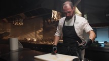Cook Filleting a Fish on the white cutting board of the restaurant