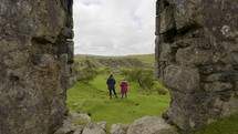 Mother And Daughter Exploring Abandoned Village Ruins On Dartmoor