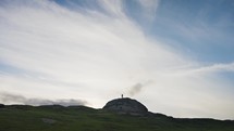 Sun sets Behind Dartmoor Tor Rock As People Climb And Hike
