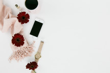 stationary, pencil, watch, iPhone, red gerber daisies, white background, nail polish, pink scarf 