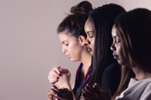 Young Devoted Women Praying Together