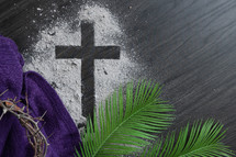 Ashes cross with crown of thorns, palm leaves and purple cloth