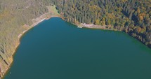 Aerial View Of St. Ana's Crater Lake In Romania During Autumn - drone shot