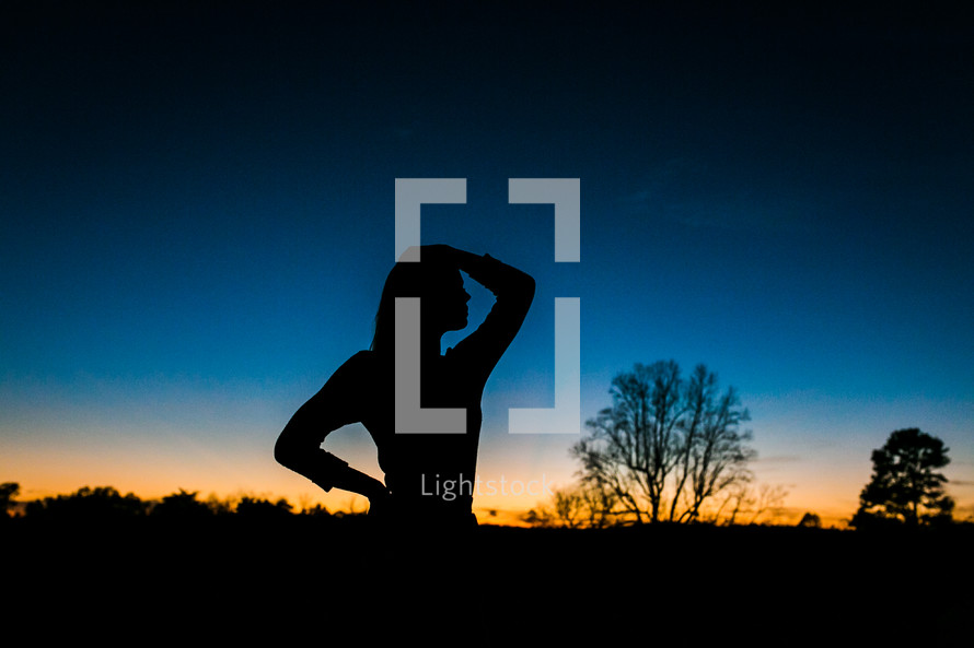 silhouette of a teen girl at dusk 