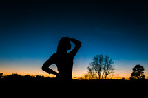 silhouette of a teen girl at dusk 