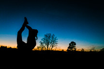 silhouette of a girl stretching 