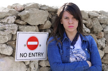 angry girl near a no entry sign