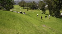 Drone shot of Golfers about to play golf. 