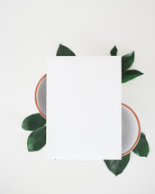 white paper on bowls and green leaves 