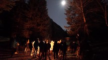 Worship community fellowship around campfire in Austria 