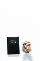 praying hands and the holy Bible 