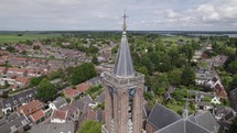 Loenen Aan De Vecht protestant Church, drone orbiting over Bell tower, Vecht river in Background, Utrecht