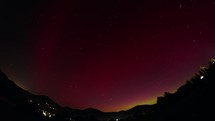 Aurora Borealis, the colorful starry sky, the aurora borealis shining through the hilly landscape, timelapse