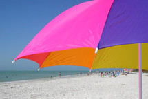 beach umbrella with people on the beach in the distance
