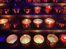 rows of prayer candles 