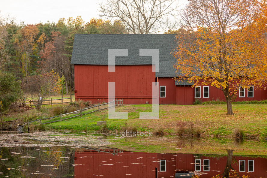 Connecticut red barn in autumn with reflection in pond