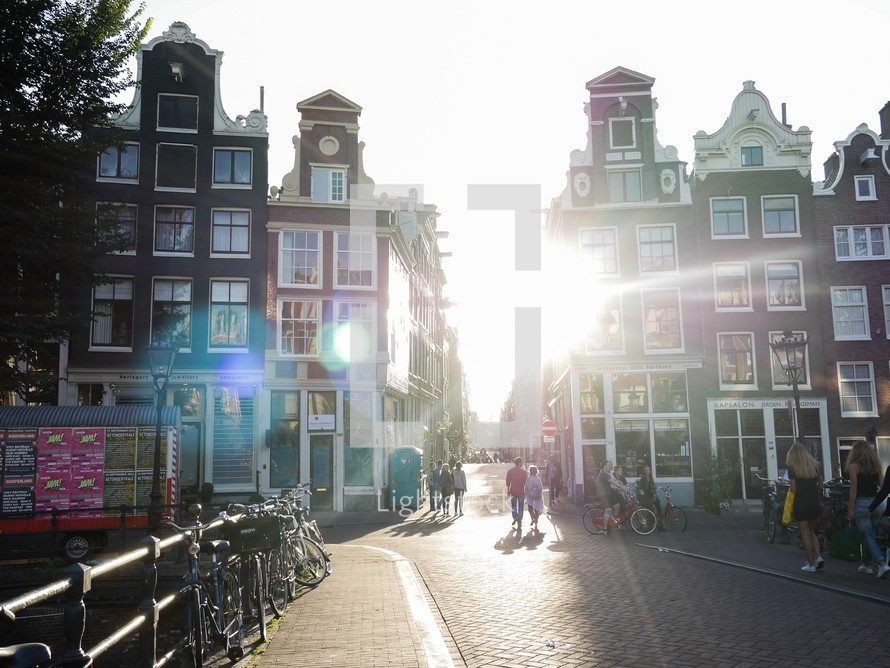 sunburst between buildings in Amsterdam, Netherlands