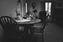elderly woman peeling apples at a kitchen table 