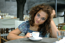 a young woman drinking coffee thinking 