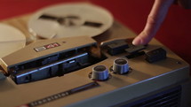 Playing a reel tape on an old tape recorder.