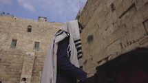 Footage of a man praying at the wailing wall