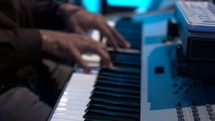 hands playing a keyboard 