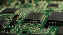 Close up of an electronic circuit board rotating