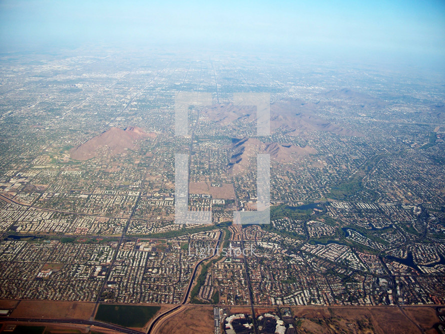 An Aerial Bird's eye View over the city of Phoenix, Arizona taken from an air plane in the southwestern United States. 