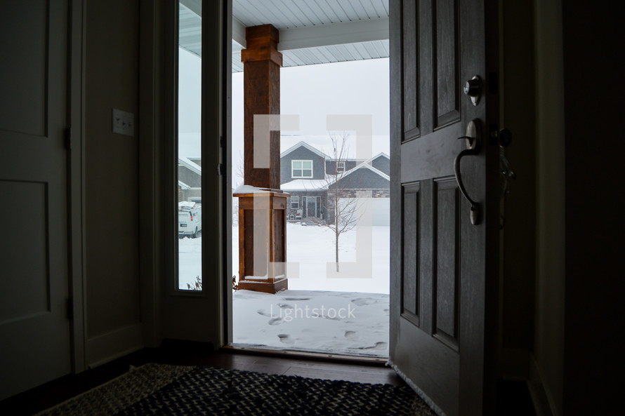 open front door with view of snow 