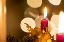 christmas candle on advent wreath with glowing lights