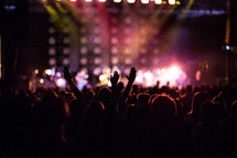 hands raised in worship at a Christian concert 