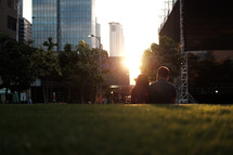 couple sitting in a city at sunset 