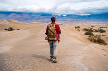 man hiking through the desert 