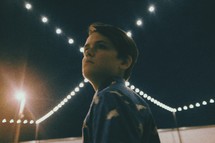a young man looking up at night 