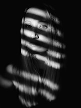 shadows on the face of a woman 