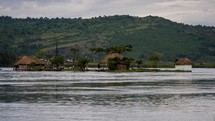 homes along a river in Uganda 