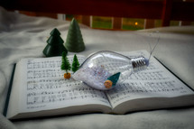bulb ornament and miniature Christmas trees on a white background 