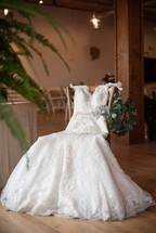wedding dress in a chair in a reception hall 