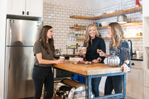 women talking in a kitchen 