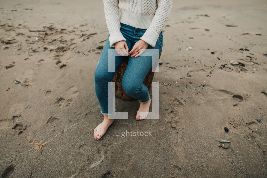 a woman sitting on a beach 