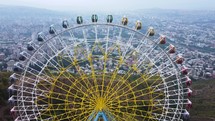 Ferris Wheel on the mountain with a city view