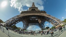 Timelapse of people traffic by the Eiffel Tower against the sky, Paris