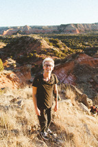 a young man hiking in a canyon 