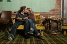 Couple kissing on a chair