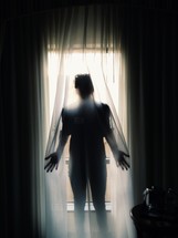 a woman standing behind a sheer curtain 